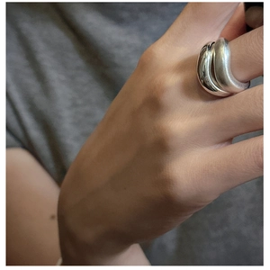 Detail of S925 silver double-cross ring featuring polished and matte brushed finishes