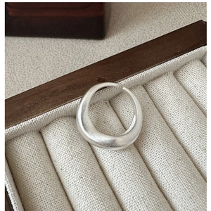Detailed view of S925 sterling silver matte ring with wavy texture in a jewelry box