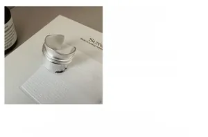 Macro detail of a wide S925 sterling silver ring with matte brushed metal texture
