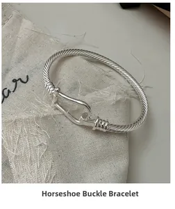Close-up of S925 silver horseshoe buckle bangle with elegant twisted rope texture