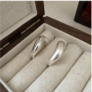 Detail of S925 silver rings with polished and matte finishes in wavy organic shapes