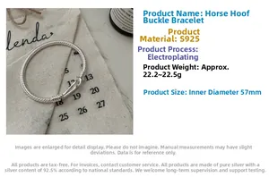 Detailed close-up of a heavy S925 sterling silver U-shaped horseshoe bangle on canvas
