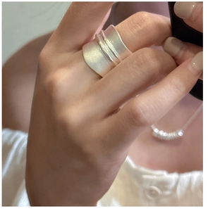 Detail view of wide S925 sterling silver ring with brushed matte finish and polished center line