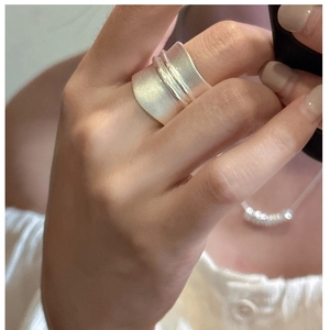 Detail of S925 sterling silver wide band ring with matte finish and polished center line