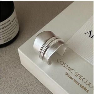 Macro shot of S925 sterling silver wide band ring featuring matte brushed finish texture