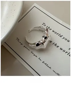 Close-up of S925 sterling silver ring with liquid metal texture and irregular wavy design