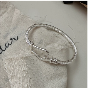 Close-up of S925 sterling silver cable twisted cuff with U-shape horseshoe buckle