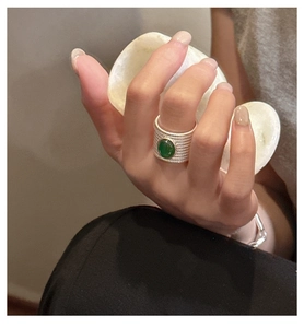 Detail of vintage S925 silver ring with green agate stone and beaded texture