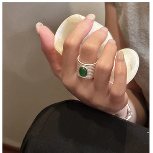 Detail of vintage S925 silver ring with green agate stone and woven textured band