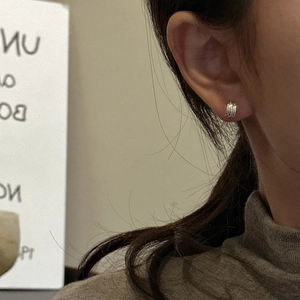Minimalist S925 sterling silver triple-layered stud earrings on a model ear