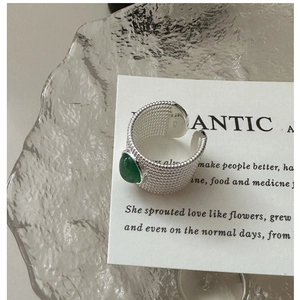 Detail of S925 sterling silver ring with green agate and woven texture finish