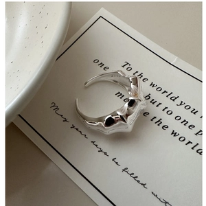 Close-up of S925 sterling silver open ring with irregular lava texture and hallmark