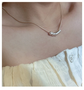 Close-up of minimalist S925 sterling silver snake chain necklace on model neck
