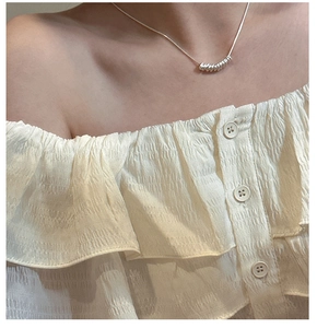 Detail of S925 sterling silver telephone wire necklace with minimalist ring pendant
