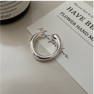 Detailansicht eines unregelmäßigen silbernen Rings mit polierter Metalloberfläche