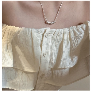 Detail of S925 sterling silver multi-ring pendant necklace on a female model neck