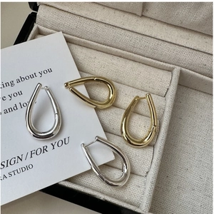 Close-up of gold and silver S925 sterling silver earrings with clear hallmark in a jewelry box