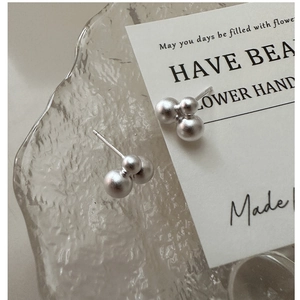 Macro shot of S925 sterling silver ball earrings with elegant matte brushed texture