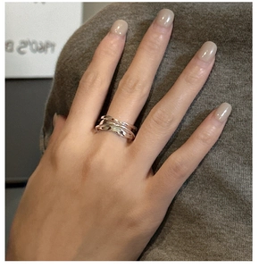 Macro view of minimalist S925 sterling silver multilayer wavy ring with mirror finish