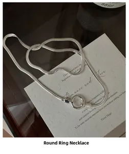 Macro detail of S925 sterling silver snake chain necklace with ring clasp on poem card