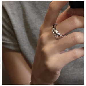 Close-up of S925 sterling silver triple interlocking rolling rings worn on a finger