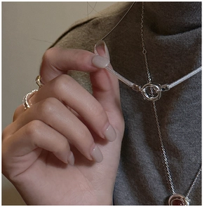 Detail of S925 sterling silver snake bone chain necklace worn over a grey turtleneck