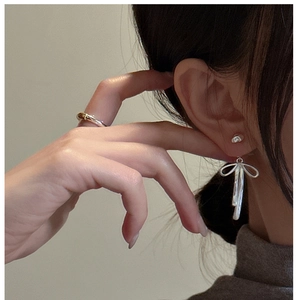 Close-up of S925 sterling silver bow tassel earrings worn by a model in French style