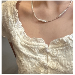 Close-up of S925 silver beaded necklace with three baroque bar pearls on a model