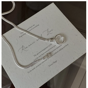 Detailed view of S925 sterling silver snake chain necklace with engraved hallmark and ring clasp