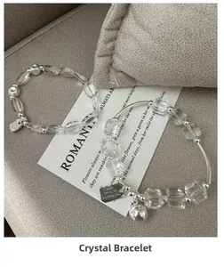 Detail of S925 silver beaded bracelets with clear crystals and engraved charms
