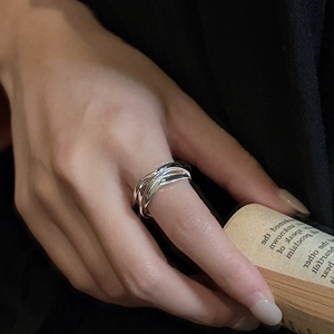 Minimalist S925 sterling silver multilayer wavy ring worn by model on vintage book