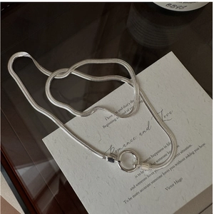 Macro view of S925 sterling silver snake bone chain featuring a secure spring ring clasp