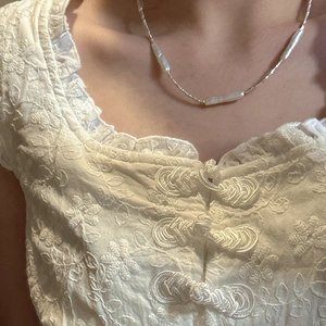 Minimalist S925 sterling silver necklace with irregular baroque pearls on a model