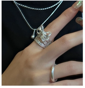 Detailed view of an S925 silver bow ring featuring a layered wrap design on finger