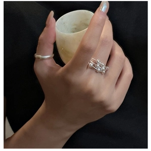 Detail of S925 sterling silver multilayer beaded ring and simple band on model