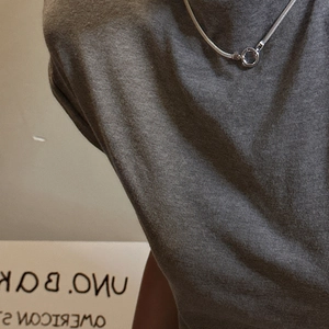 Minimalist S925 sterling silver snake chain necklace with circular clasp on a model