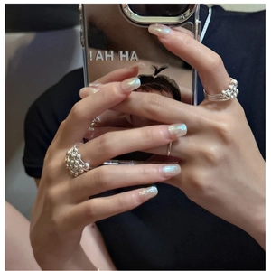 Detailed view of stacked S925 sterling silver beaded bubble rings worn on fingers