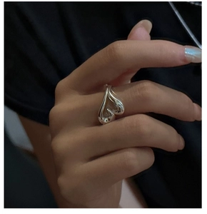 Close-up of S925 sterling silver heart open ring on model finger with minimalist design