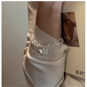 Detail of S925 silver beaded bracelet with clear crystals and charms on a wrist