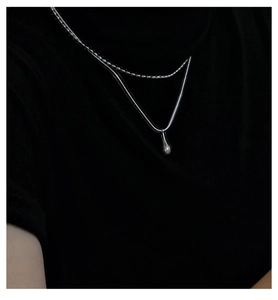 Detail of S925 sterling silver double-layer necklace with a smooth water drop pendant