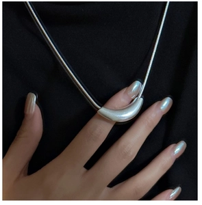 Detail of S925 sterling silver curved bar necklace with matte finish on snake chain