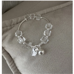 Detailed shot of S925 silver beaded bracelet with clear crystals and engraved tags