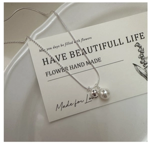 Detail view of S925 silver necklace with shell pearl pendant on a dual-style chain