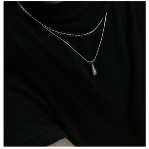 Close-up of double layer S925 sterling silver necklace with teardrop pendant on neck