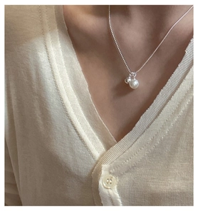 Close-up of S925 sterling silver necklace with white shell pearl and minimalist bead