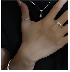 Minimalist S925 sterling silver jewelry set featuring rings, bracelet, and drop pendant
