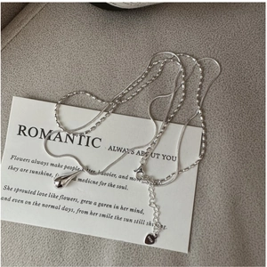 Detail of S925 sterling silver double layer necklace with water drop pendant on card