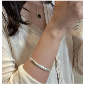 Minimalist S925 sterling silver matte cuff bracelet shown in a lifestyle setting