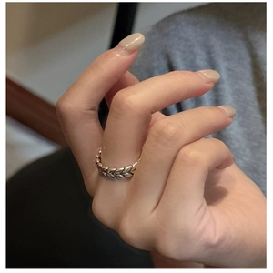 Macro detail of S925 sterling silver ring with vintage wheat ear texture on finger