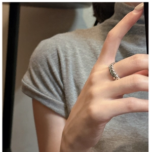 Detailed view of vintage S925 sterling silver wheat ear ring on model's finger